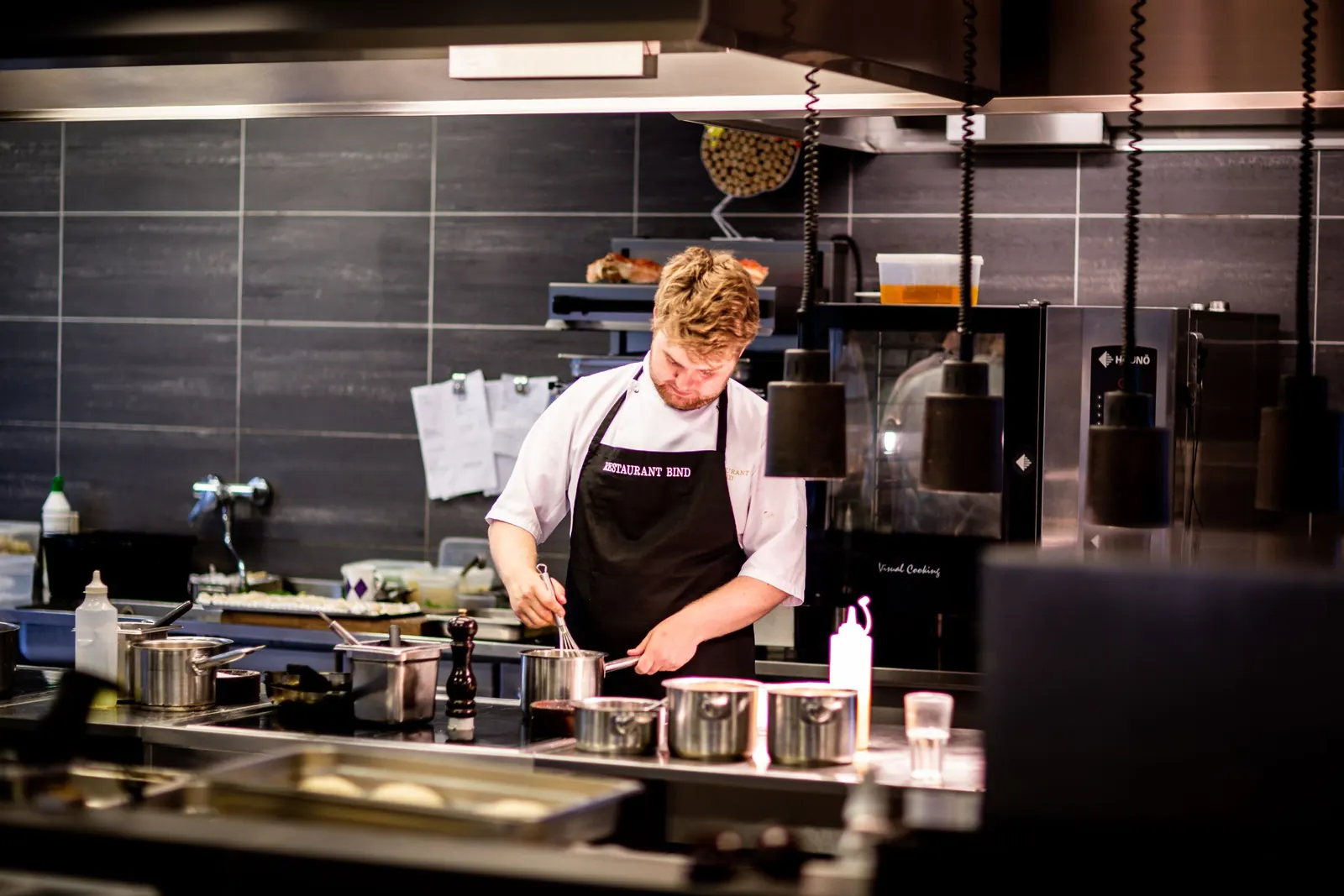 A chef cooking over flames