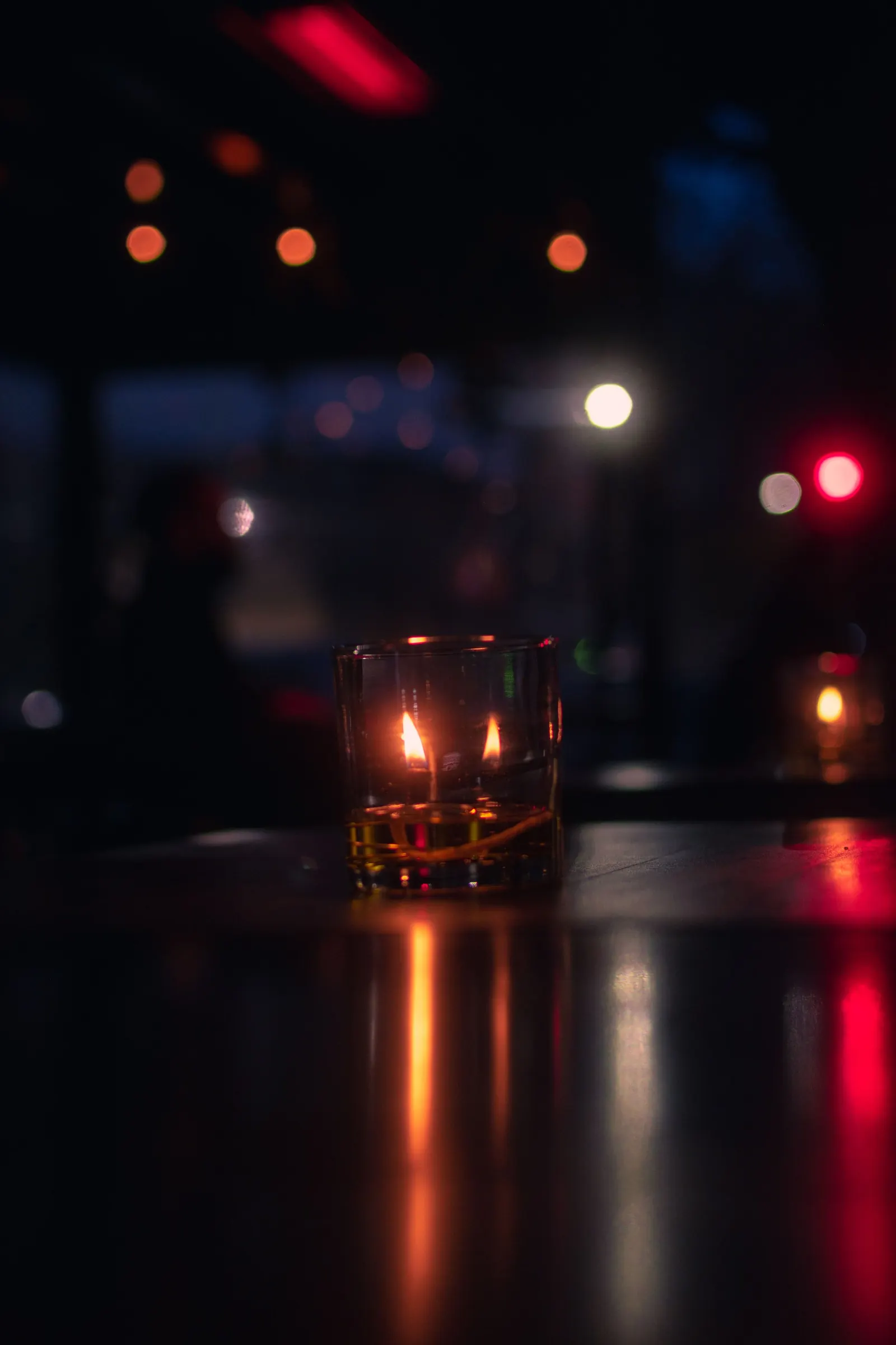 A single candle on a table in a dark room